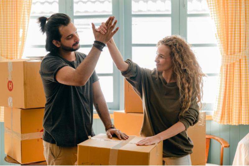 A couple high-fiving each other after finding the best interstate movers.