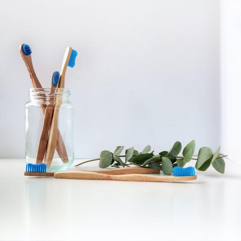 A glass jar of wooden toothbrushes